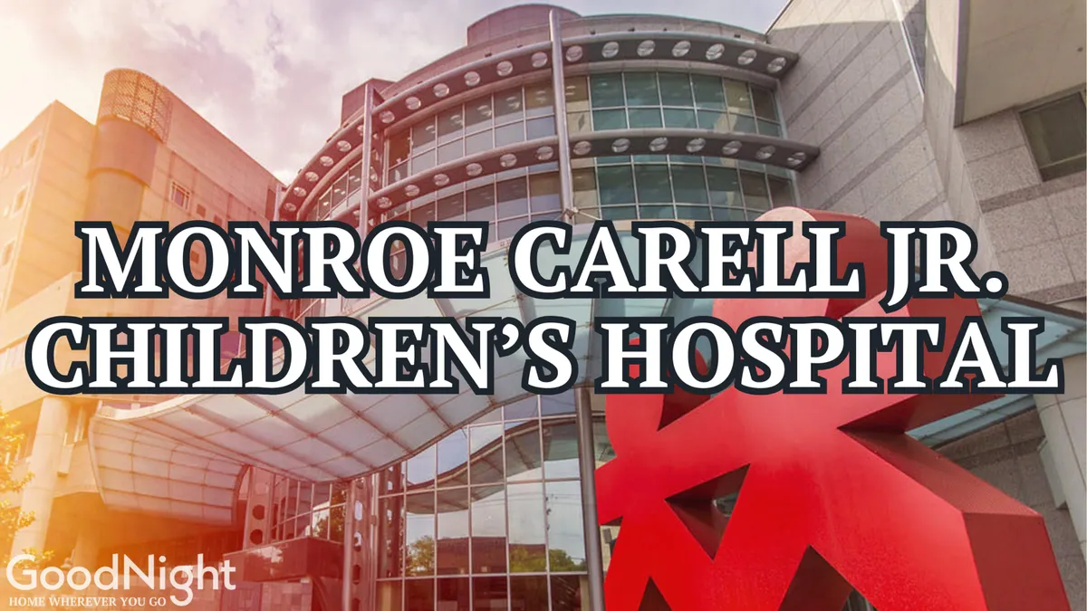A modern hospital building accented by a large red sculpture and a welcoming entrance canopy. The exterior is spacious, reflecting a sense of care and accessibility—underscoring the convenience for guests visiting for medical conferences or hospital-related purposes.