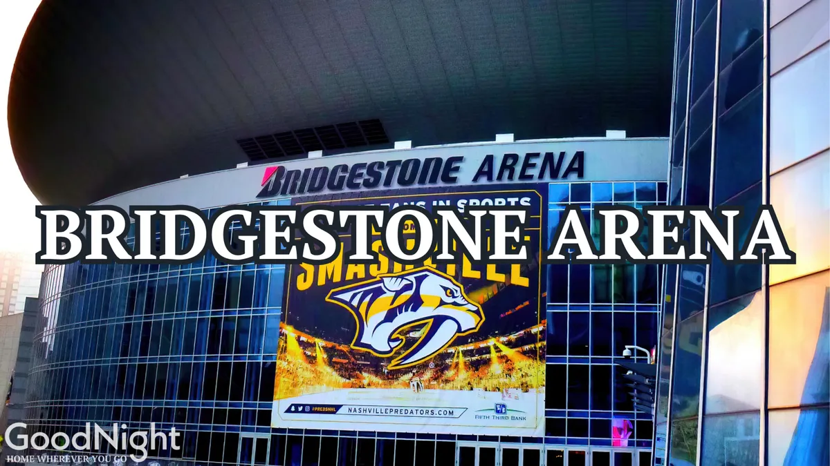 A dynamic exterior shot of Bridgestone Arena, featuring its modern glass facade and the Nashville Predators banner. The lively atmosphere hints at the energy of concerts and major sports events, with community activity visible around the building.
